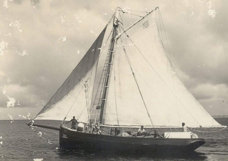 A timeless snapshot of maritime grace, this black and white photograph captures the elegance of a classic sailing yacht. Gliding effortlessly across the water, her sails billow with the strength of the wind, a sloop rigged for the dual pleasures of racing and leisurely marine exploration. The yacht's sleek hull contrasts with the tranquil sea, while her crew seems at ease, mastering the art of sailing with skill and confidence. A glimpse into a bygone era of seafaring, the photograph is a tribute to the enduring allure of wind-powered vessels and the age-old connection between humans and the vast, mysterious ocean. FB_IMG_1478126719179.jpg