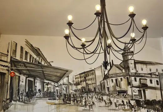 Black Chandelier Over a Town Square Wall Drawing