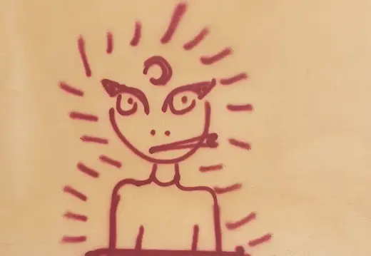 Pequeño grafiti de dibujos animados en una pared de azulejos.