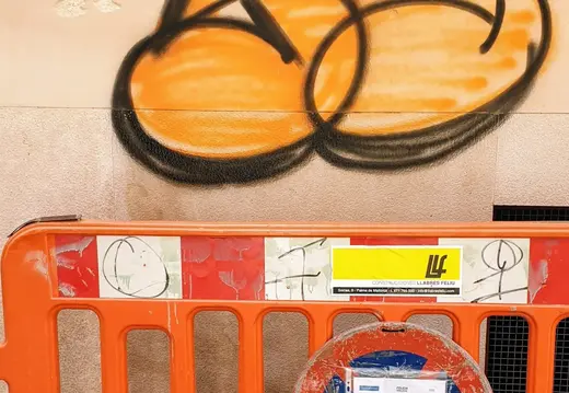 Graffiti Behind a Road Barrier