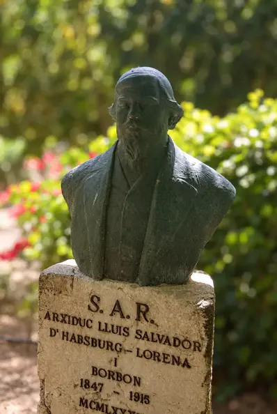 Bronze bust framed by garden bokeh.webp