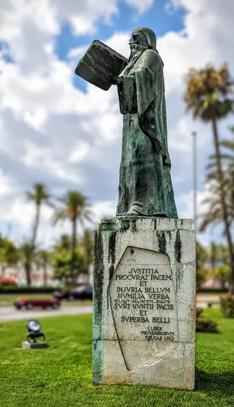 Bronze statue with book.webp
